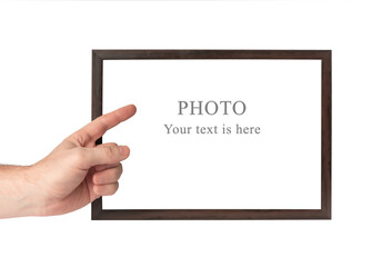 A man's hand holds a wooden frame on a white isolated background.