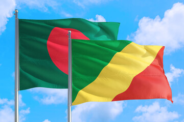 Republic Of The Congo and Bangladesh national flag waving in the windy deep blue sky. Diplomacy and international relations concept.