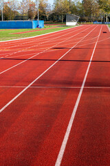 Fototapeta premium Red running lane on outdoor school stadium
