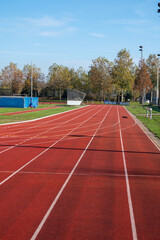Red running lane on outdoor school stadium