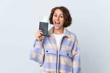 Young English woman isolated on white background happy in vacation with passport and plane tickets