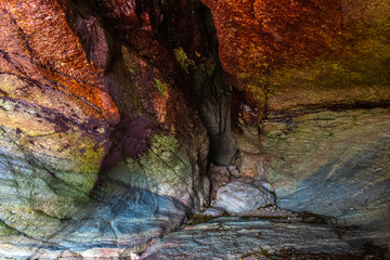 A small cave with blood red colors in the Vendée corniche in the town of Bretignoles Sur Mer.