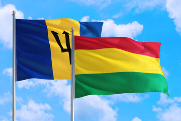 Bolivia and Barbados national flag waving in the windy deep blue sky. Diplomacy and international relations concept.