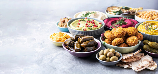 Mediterranean appetizer concept. Arabic traditional cuisine. Middle Eastern meze with pita, olives,...