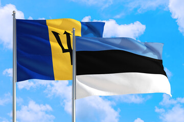 Estonia and Barbados national flag waving in the windy deep blue sky. Diplomacy and international relations concept.