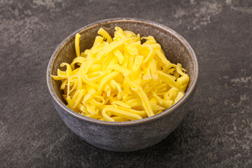 Shredded yellow cheese in the bowl