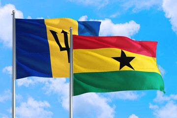 Ghana and Barbados national flag waving in the windy deep blue sky. Diplomacy and international relations concept.