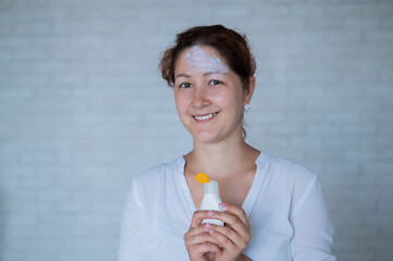 Portrait of a Caucasian woman with vitiligo diseas uses sunscreen
