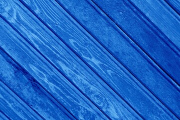 Striped wooden background diagonal abstract blue bright trendy neon color with boards surface texture, retro style concept.