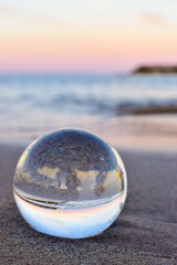 Lens ball on the beach with sun