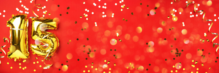Gold foil balloon number, digit fifteen. Birthday greeting card, inscription 15. Anniversary celebration event. Banner. Stylish golden numeral, light bokeh, glitter, red background. Numerical digit