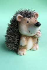 Decorative brown hedgehog on green background © Berkaynb