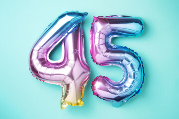 Rainbow foil balloon number, digit forty-five. Birthday greeting card with inscription 45....