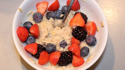 colorful tasty healthy mixed fruits with oatmeal