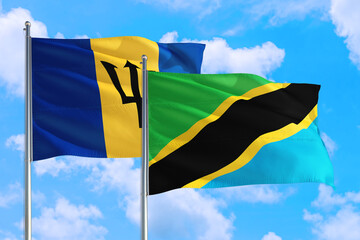 Tanzania and Barbados national flag waving in the windy deep blue sky. Diplomacy and international relations concept.