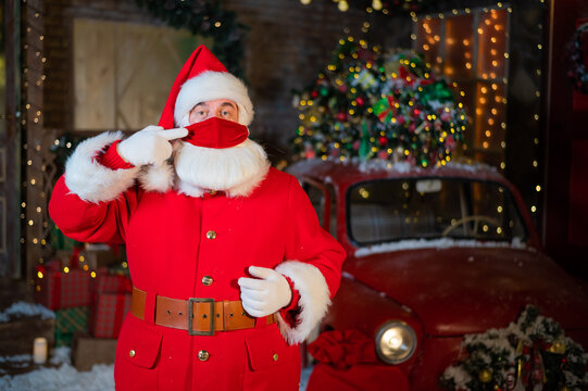 Portrait Of Santa Claus Wearing A Protective Mask. Winter Holiday During The Coronavirus Pandemic