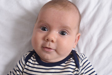 baby lying looking at camera