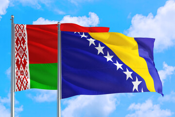 Bosnia Herzegovina and Belarus national flag waving in the windy deep blue sky. Diplomacy and international relations concept.