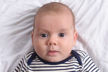 baby lying looking at camera