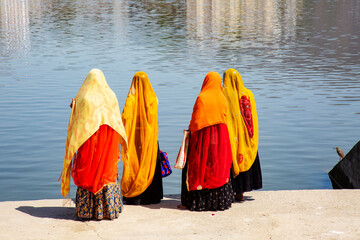 Four Indian women ready to sacred bath in Pushkar lake, Rajasthan, India