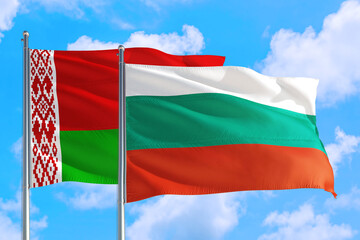 Fototapeta na wymiar Bulgaria and Belarus national flag waving in the windy deep blue sky. Diplomacy and international relations concept.