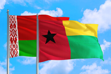 Guinea and Belarus national flag waving in the windy deep blue sky. Diplomacy and international relations concept.