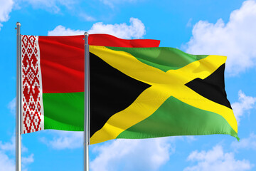 Jamaica and Belarus national flag waving in the windy deep blue sky. Diplomacy and international relations concept.