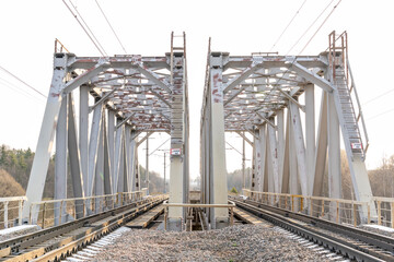metal railway bridge over a small river, selective focus, tinted image