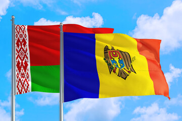 Moldova and Belarus national flag waving in the windy deep blue sky. Diplomacy and international relations concept.