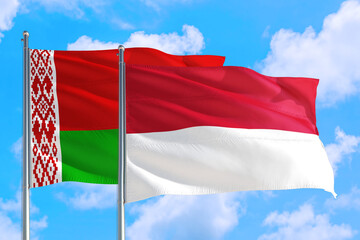 Monaco and Belarus national flag waving in the windy deep blue sky. Diplomacy and international relations concept.