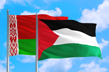 Palestine and Belarus national flag waving in the windy deep blue sky. Diplomacy and international relations concept.