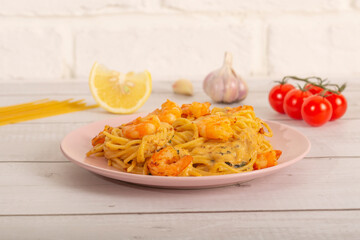 Spaghetti with shrimps with ingredients. Spaghetti, tomatoes, garlic lemon. Side view Selective focus