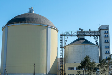 Fototapeta premium sugar factory. Sugar Plant Silo and Elevator Tower. Large concrete barrels of sugar. Granary elevator. Agro manufacturing plant for processing drying cleaning