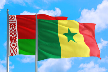 Senegal and Belarus national flag waving in the windy deep blue sky. Diplomacy and international relations concept.
