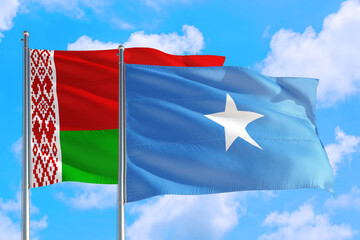 Somalia and Belarus national flag waving in the windy deep blue sky. Diplomacy and international relations concept.