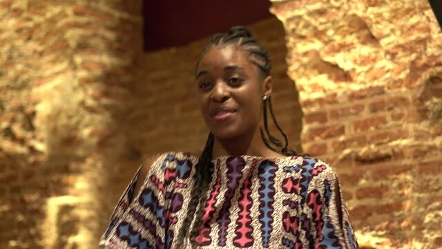 Beautiful African American woman dancing in party room.