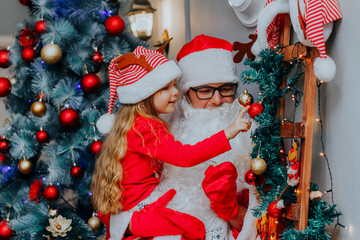 The child is in Santa's arms. New year for children. Meeting with Santa.