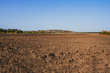 Fresh soil, arable land and blue sky.