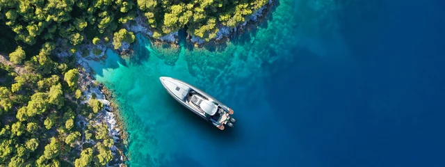 Foto op Canvas Aerial drone ultra wide panoramic photo of luxury yacht anchored in tropical exotic island with crystal clear turquoise sea and pine trees © aerial-drone