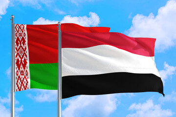 Yemen and Belarus national flag waving in the windy deep blue sky. Diplomacy and international relations concept.