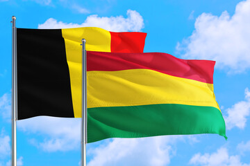 Bolivia and Belgium national flag waving in the windy deep blue sky. Diplomacy and international relations concept.