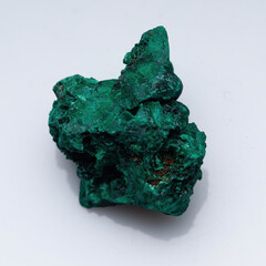 Malachite green ore on a white background. Natural green malachite