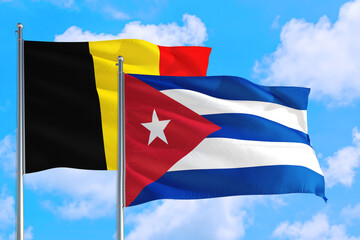 Cuba and Belgium national flag waving in the windy deep blue sky. Diplomacy and international relations concept.