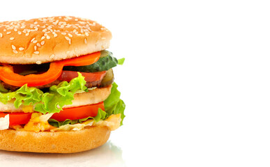 Big appetizing burger, hamburger with vegetables close-up side view isolated on white background