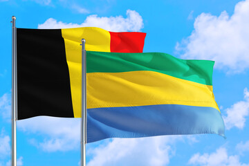 Gabon and Belgium national flag waving in the windy deep blue sky. Diplomacy and international relations concept.