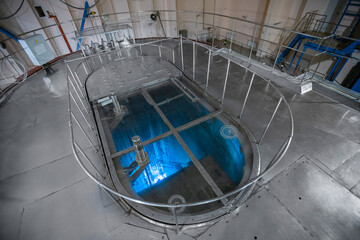 Blue glow water of nuclear reactor core powered, caused by Cherenkov radiation, fuel plates industrial uran © Parilov