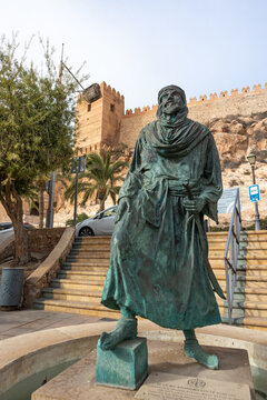 Spain; Nov 2020: Sculpture of Jayran al-Amiri, the first Arab king of Almer&iacute;a in front of the Alcazaba citadel, city walls with defensive towers built in Almer&iacute;a, Andalusia, South Spain