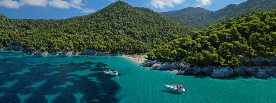 Aerial drone ultra wide panoramic photo of famous turquoise pebble beach of Kastani where famous Mamma Mia movie was filmed, Skopelos island, Sporades, Greece