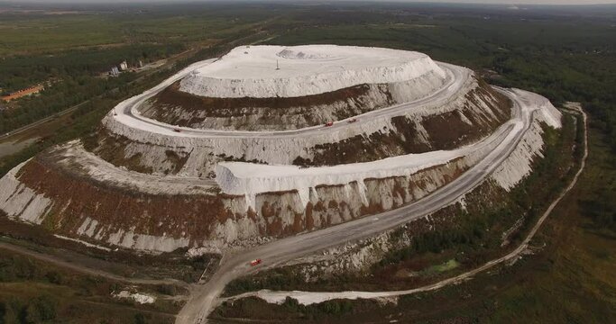 4K sunny morning aerial video of huge industrial phosphorite powder man made "White Mountain" near small town Voskresensk in Moscow Oblast near Moscow, Russia. Phosphorite is still mined there