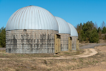 silver silos on agro manufacturing plant for processing drying cleaning and storage of agricultural products, flour, cereals and grain. Large iron barrels of grain. Granary elevator